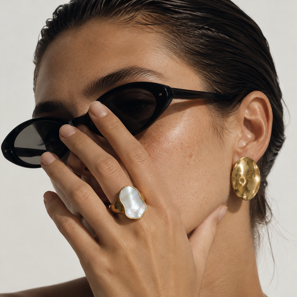 The Sierra Ring worn on hand – 18K gold natural mother of pearl organic statement ring by Arina Linea