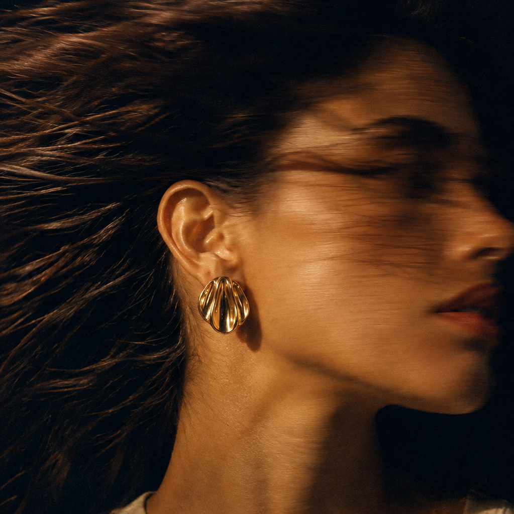 Alba Earrings Gold worn on model – sculptural rippled 18K gold stud earrings by Arina Linea